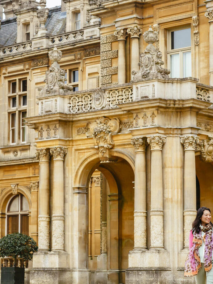 A young, happy couple walking outside a manor