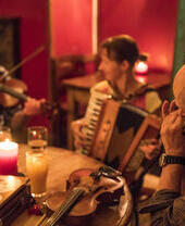 Three musicians playing music in a pub.