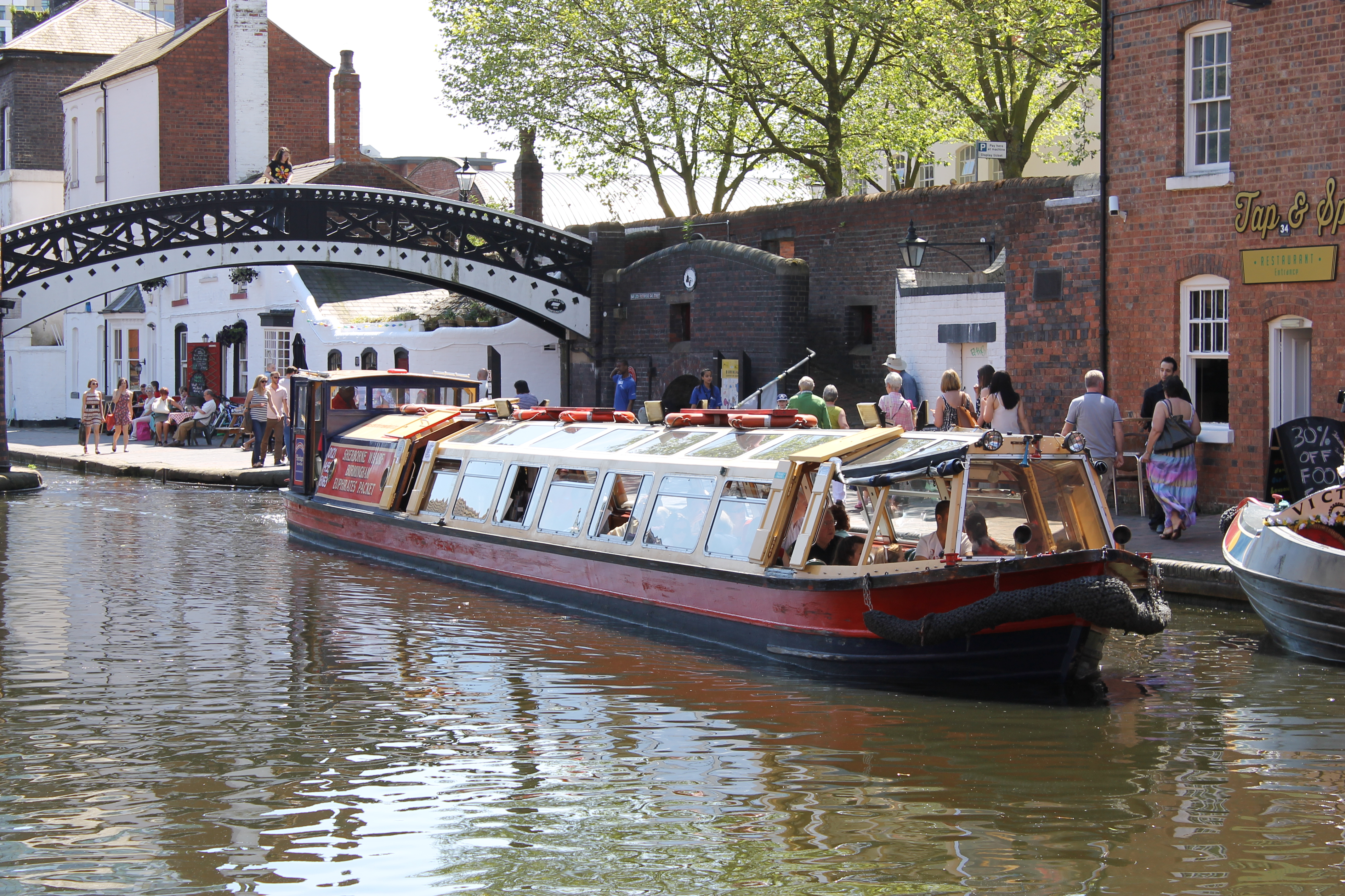 A barge sailing down a canal in Birmingham, near Sherborne Wharf