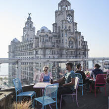 Rooftop terrace restaurant with expansive city views.