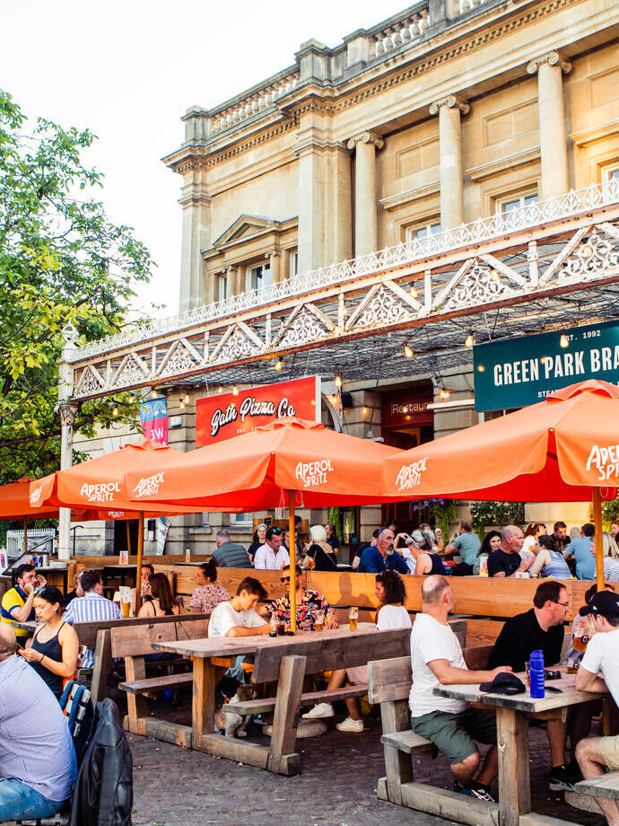 People sat on front terrace in daytime.