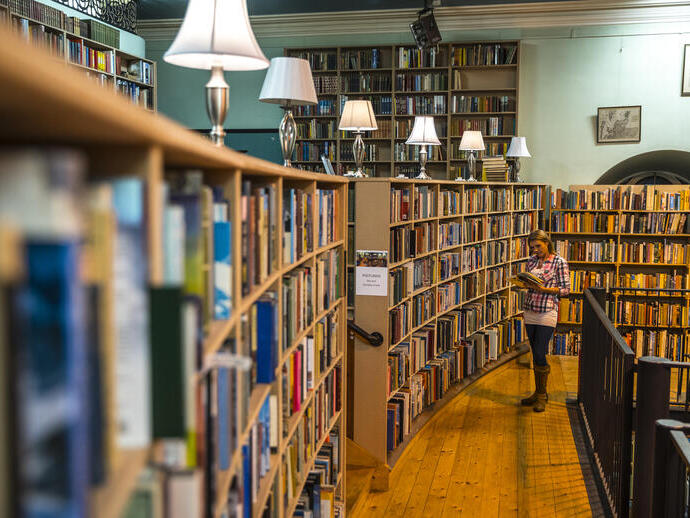 Woman looking at a book in a bookshop