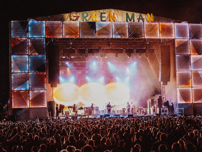 Crowd at a music festival in front of the stage at night