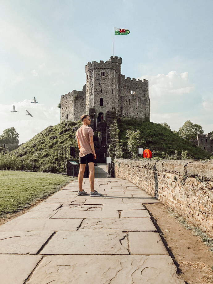Homme debout sur un chemin devant un château