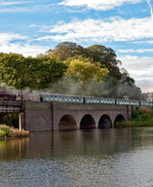 A train crosses a bridge as part of the Great Central Railway