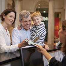 Family buying entry tickets in a museum