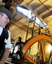 A man demonstrating machinery at Abbey Pumping Station in Leicester