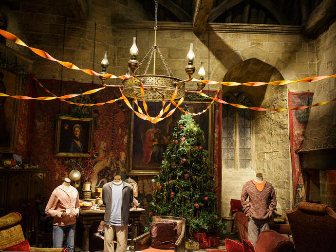 Christmas tree in a common room with casual student clothes on dummies