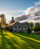 Sun setting over Dewer’s Aberfeldy Distillery