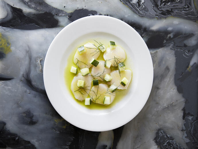 A fine dining plate of scallop cevice.