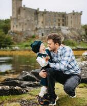 A man and boy outside Dunvegan Castle