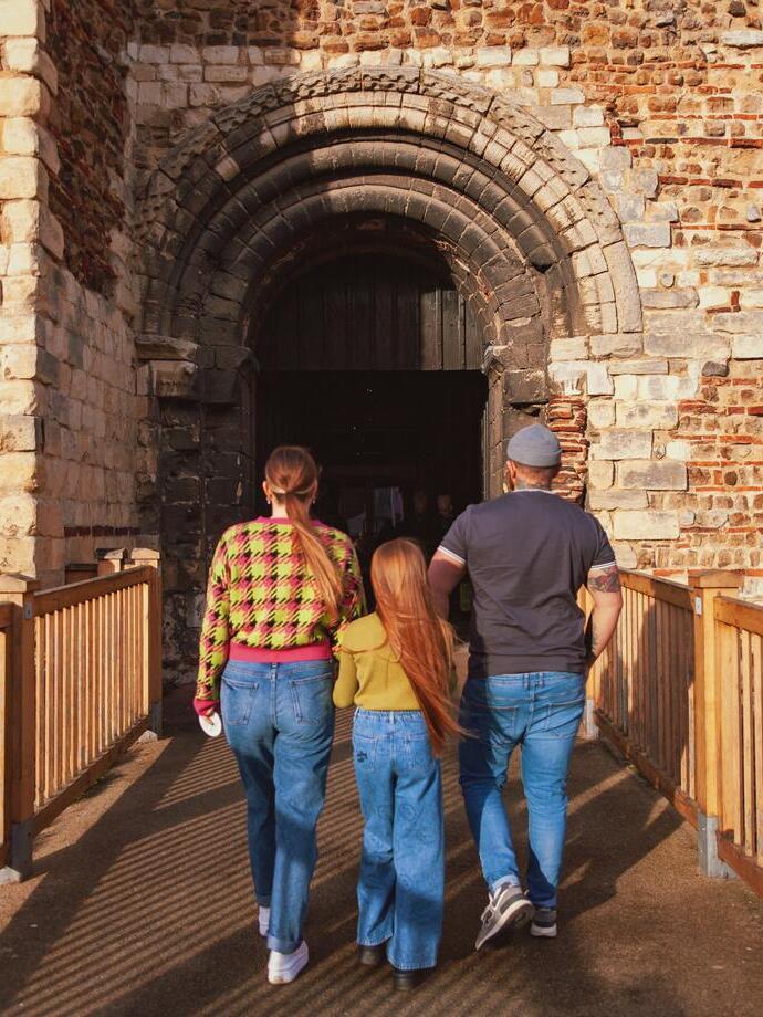 Family walking towards a castle