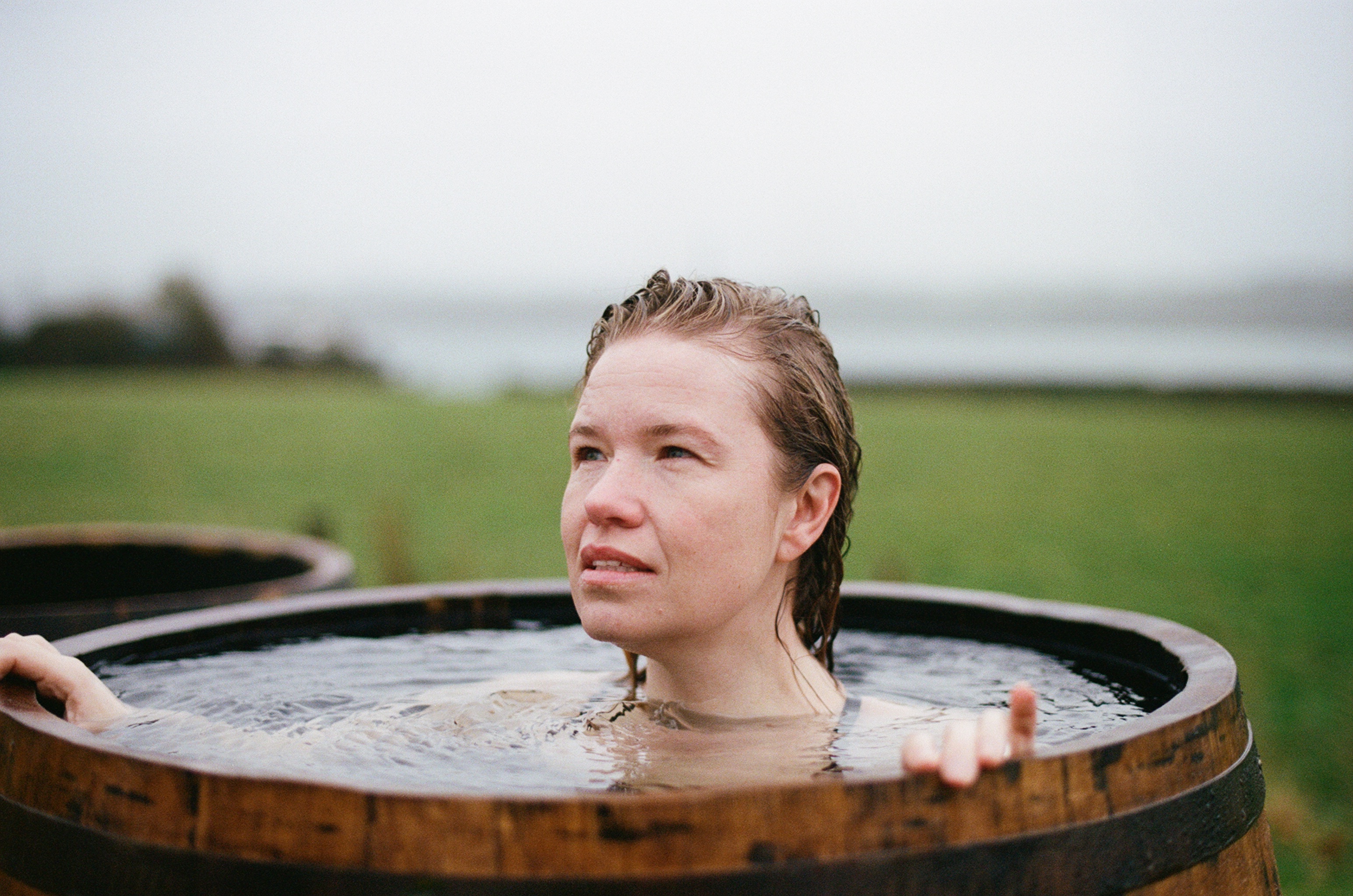 Woman in a barrel of water at Halen Môn - Anglesey Sea Salt Company