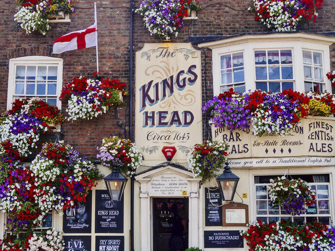 A pub decorated with colourful hanging baskets filled with flowers