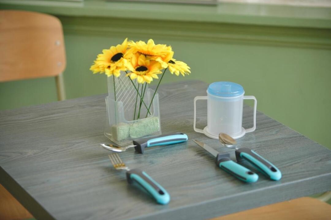 Small table set with children utensils and flowers