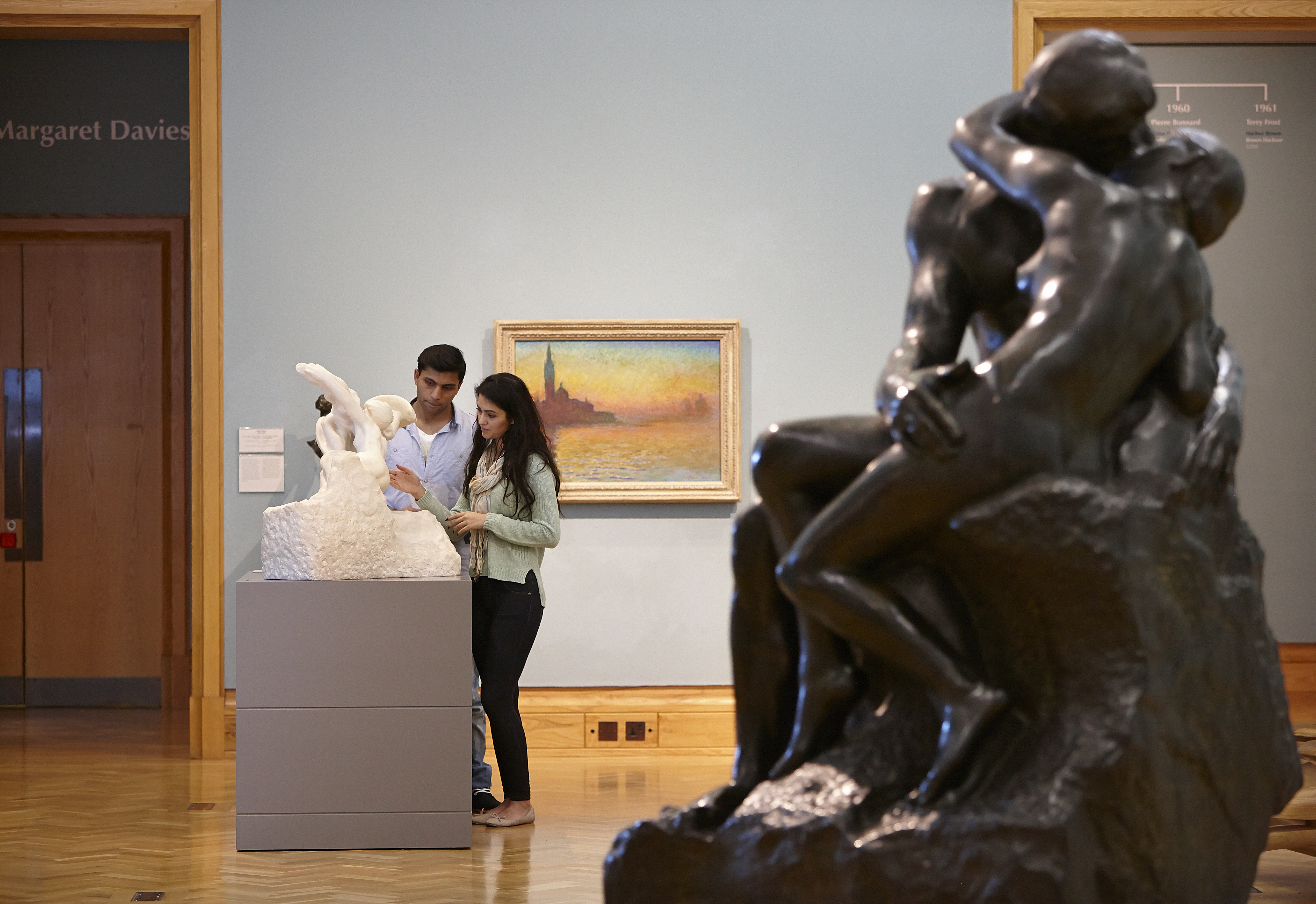 Man and woman viewing artwork in a museum