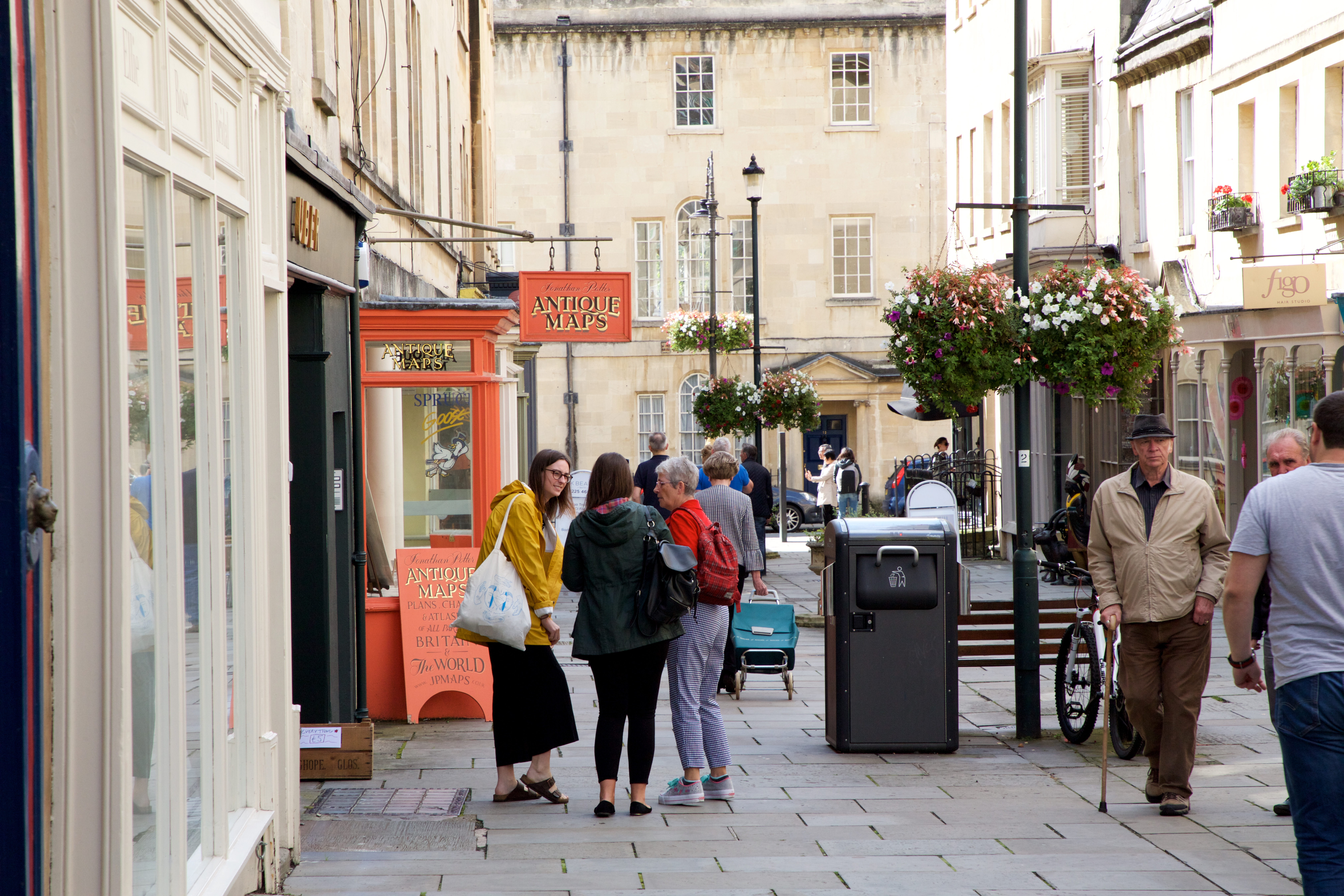 Groups of people walking down a street in Bath's Upper City