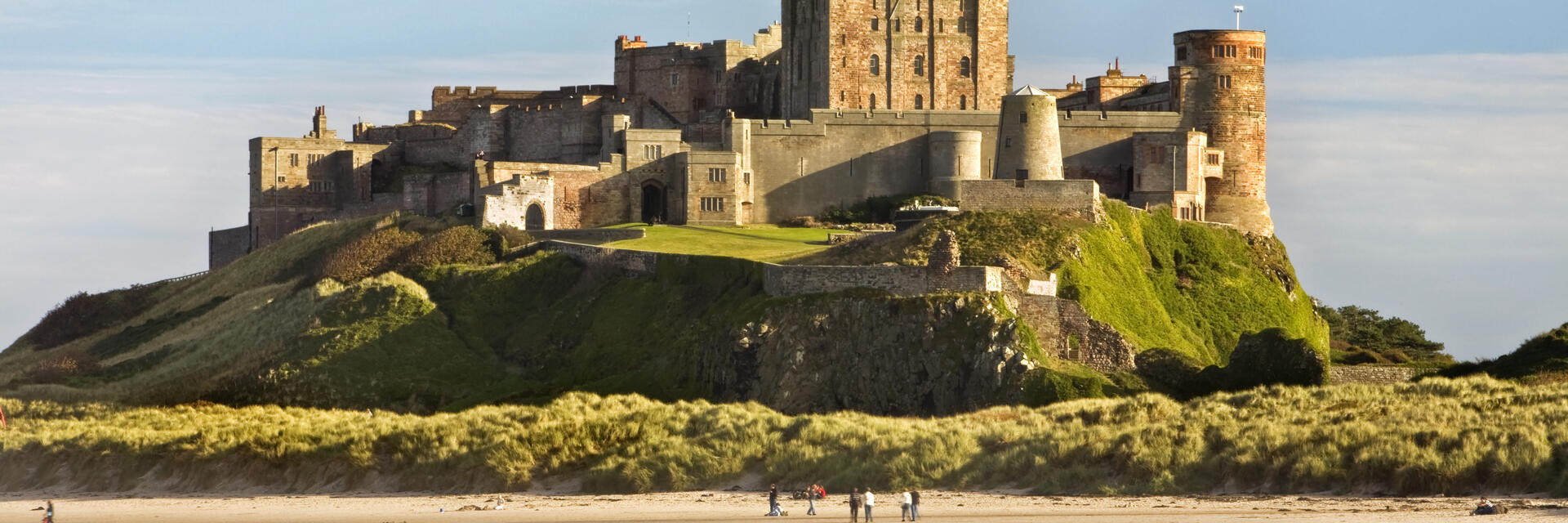 A castle on a cliff by a beach