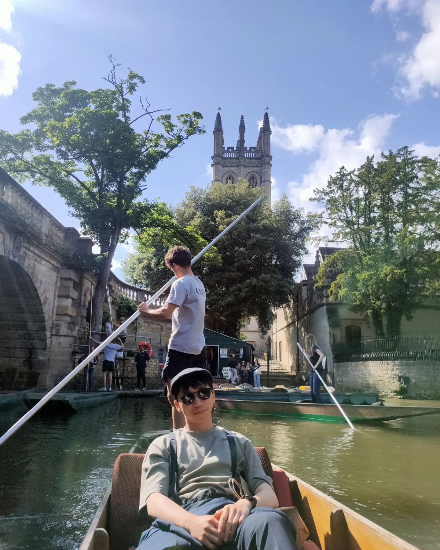 A man enjoying a punt down the river, next to Oxford University