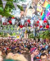 Crowds of people walking along Manchester's Canal Street