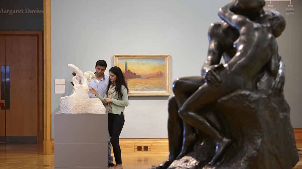 Man and woman viewing artwork in a museum