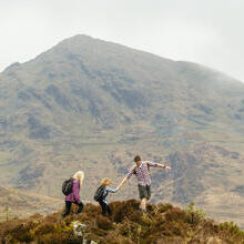 Man, woman and a child walking in the mountains
