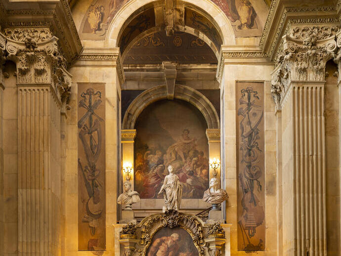 Interior shot of ornate fireplace and arch with painted ceiling and frescoes