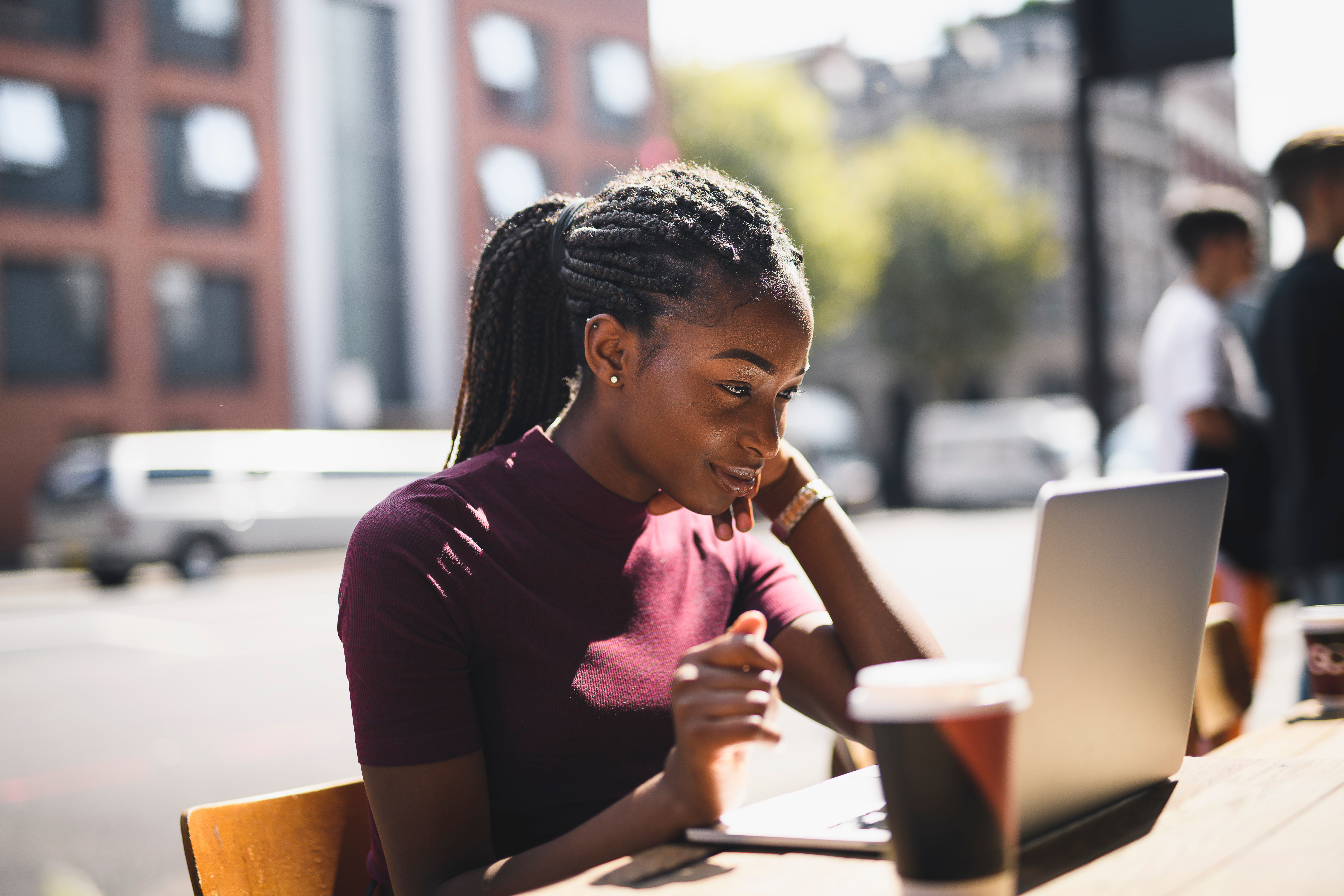 Woman using a laptop at an outdoor café