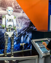 A child playing with an interactive exhibit at a science museum.
