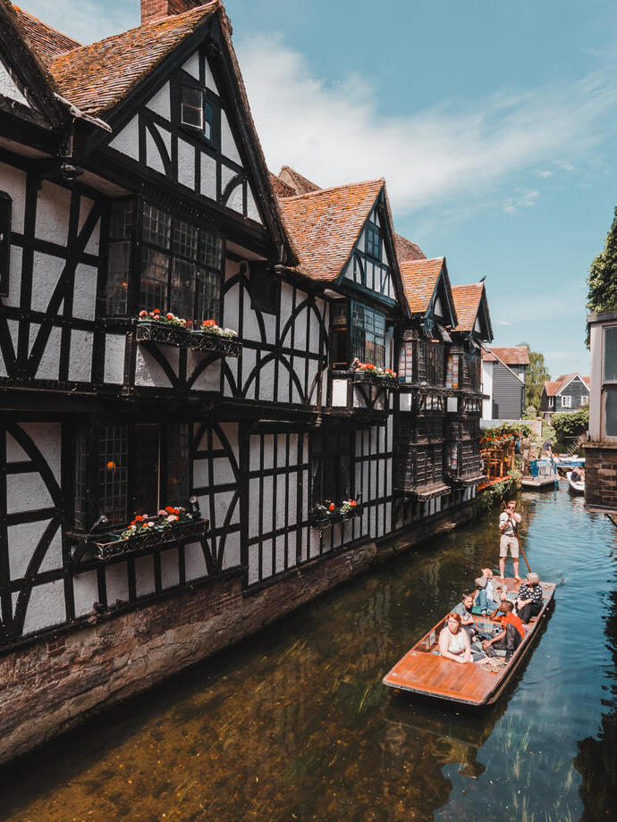 Punting between white houses with black beams