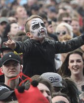 A man in a crowd with facepaint at Bloodstock festival