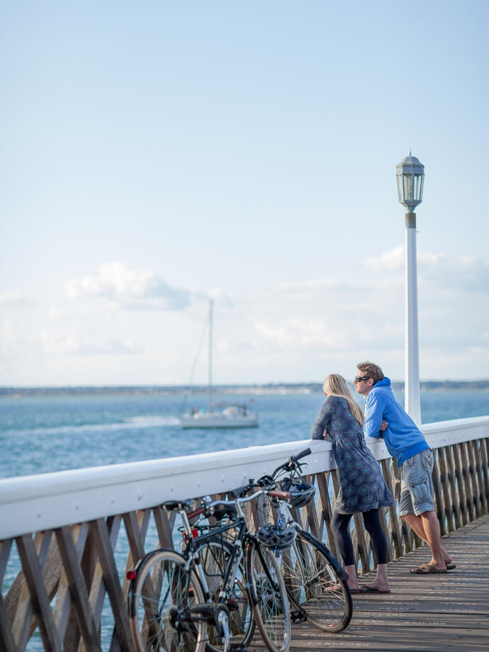 Man and woman on a pier with bikes