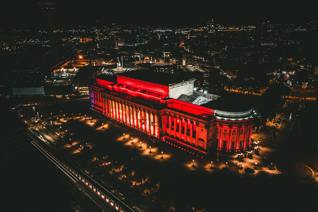 Aerial view of building lit up at night