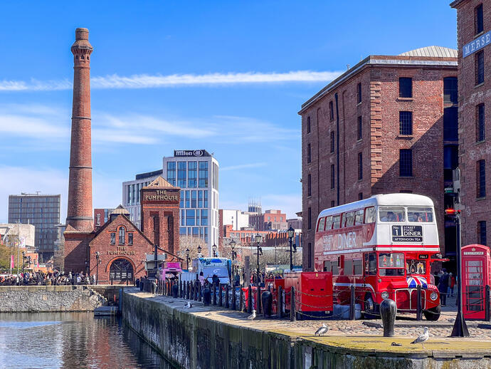Dockside scene showing a double decker bus and industrial buildings beside a lock