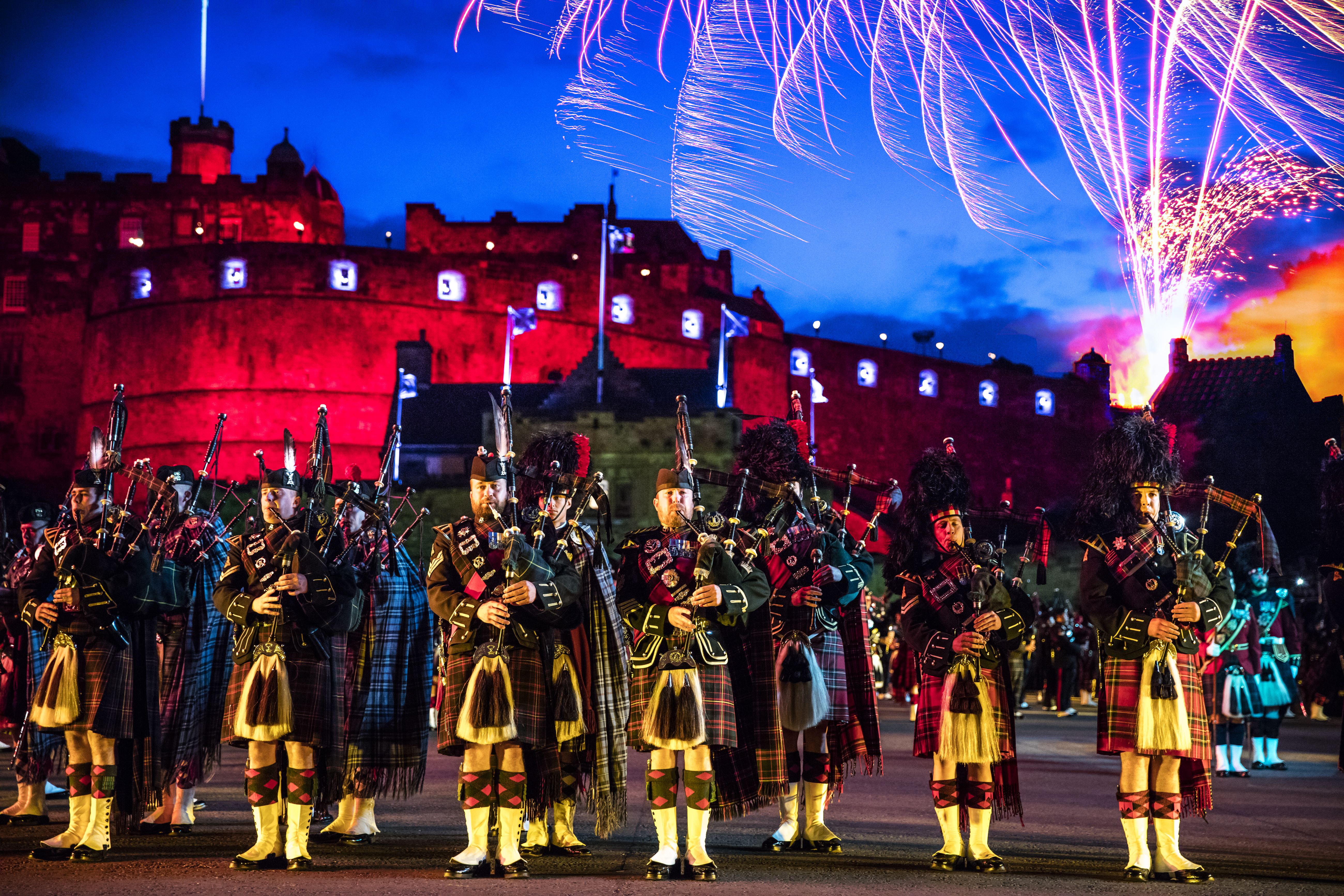 The arena at the Edinburgh Military Tattoo during a performance of the military event, parade ground and packed spectator seating.