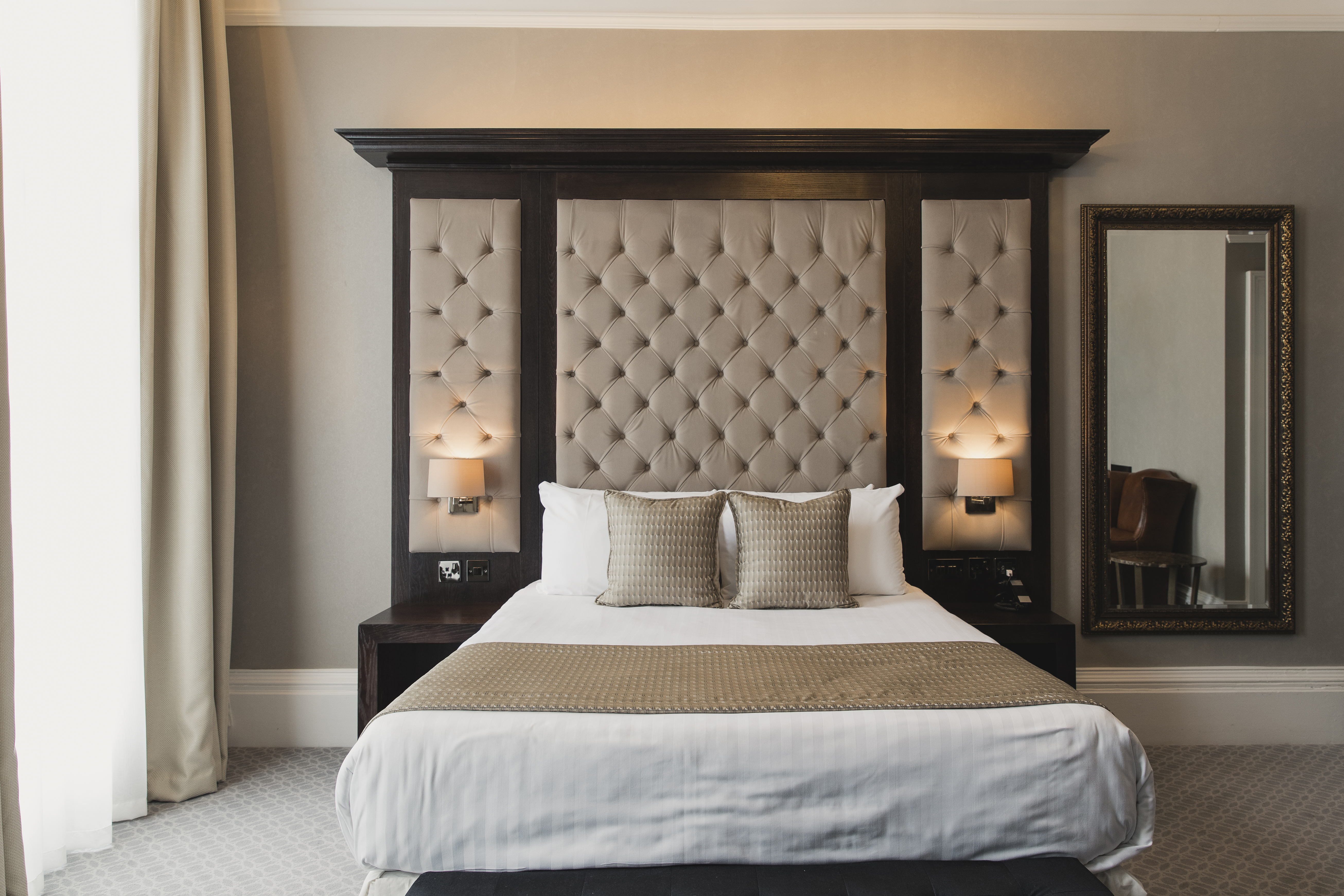 A luxury hotel bedroom with a double bed