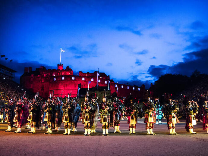 Marching band and light show projecting onto the castle
