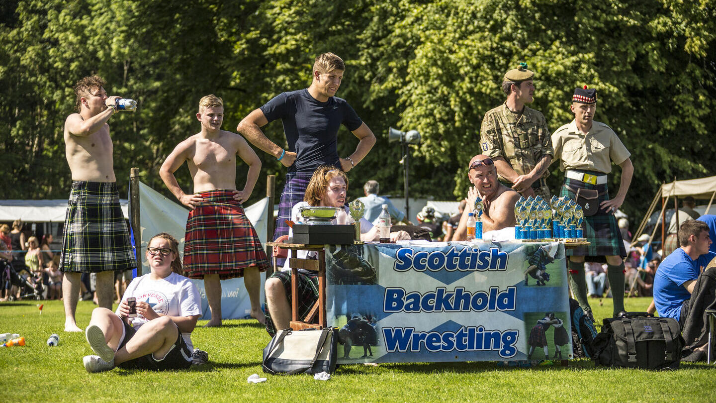 Inveraray Argyll Highland Games at Inveraray Castle. Group of men wearing kilts.