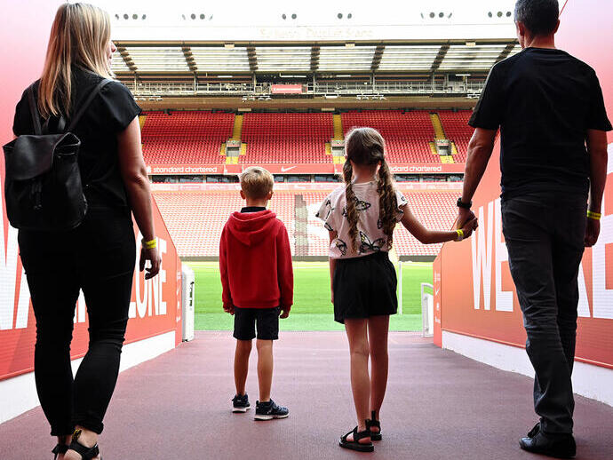 A family walking through the Tunnel to view the pitch as part of the stadium tour.