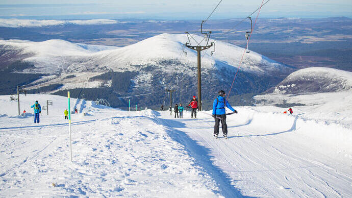 Group of skiers on a snowy slope in the Cairngorms National Park, Scotland