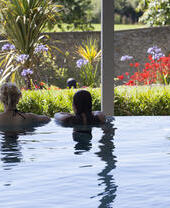 Two people relaxing in a spa pool in Cornwall