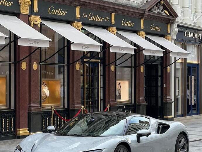 Street with a sports car outside a watch shop
