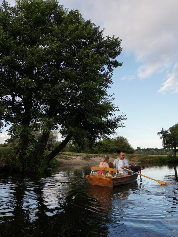 A family in a rowing boat on a river