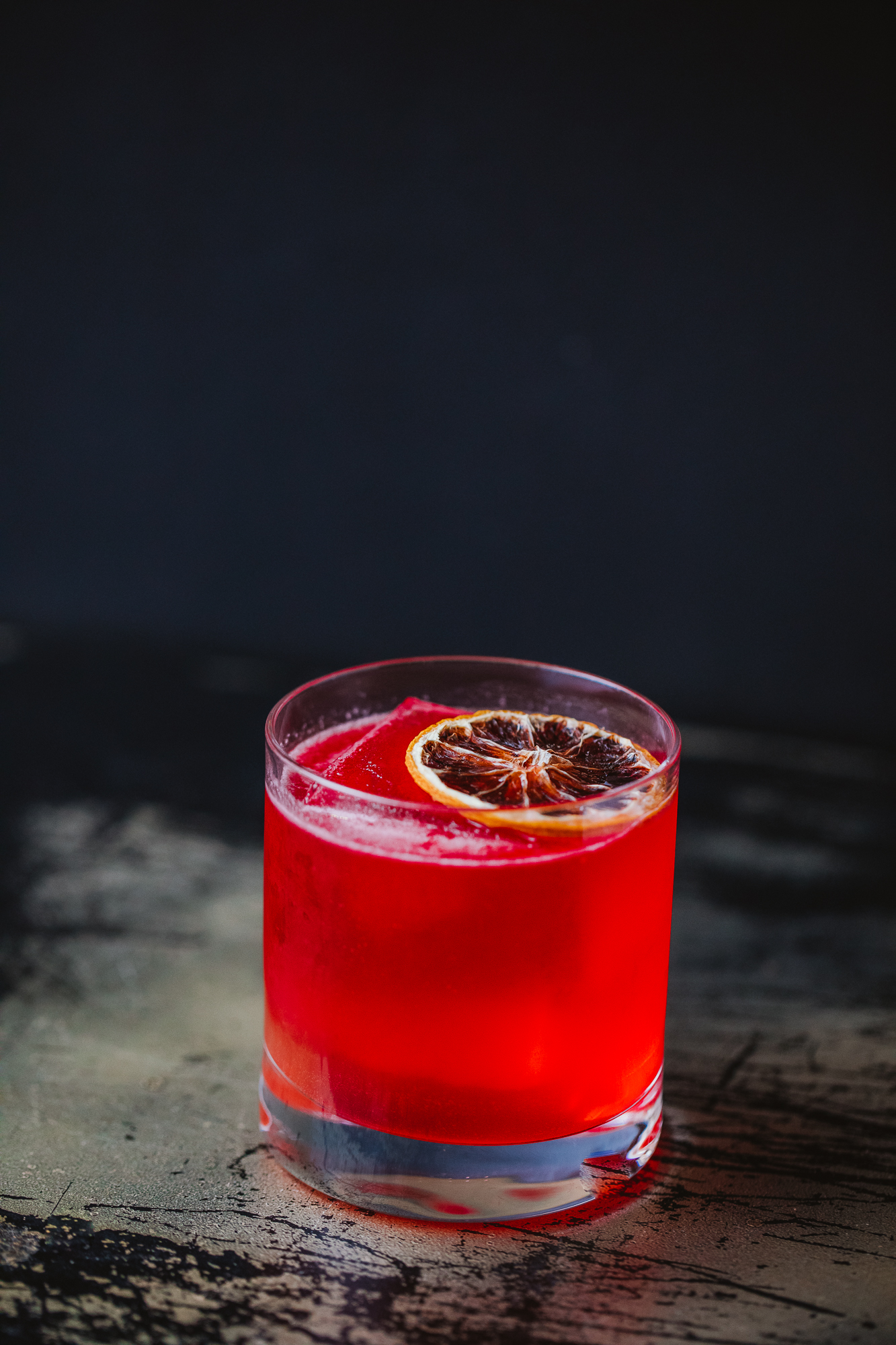 Glass with red coloured cocktail drink