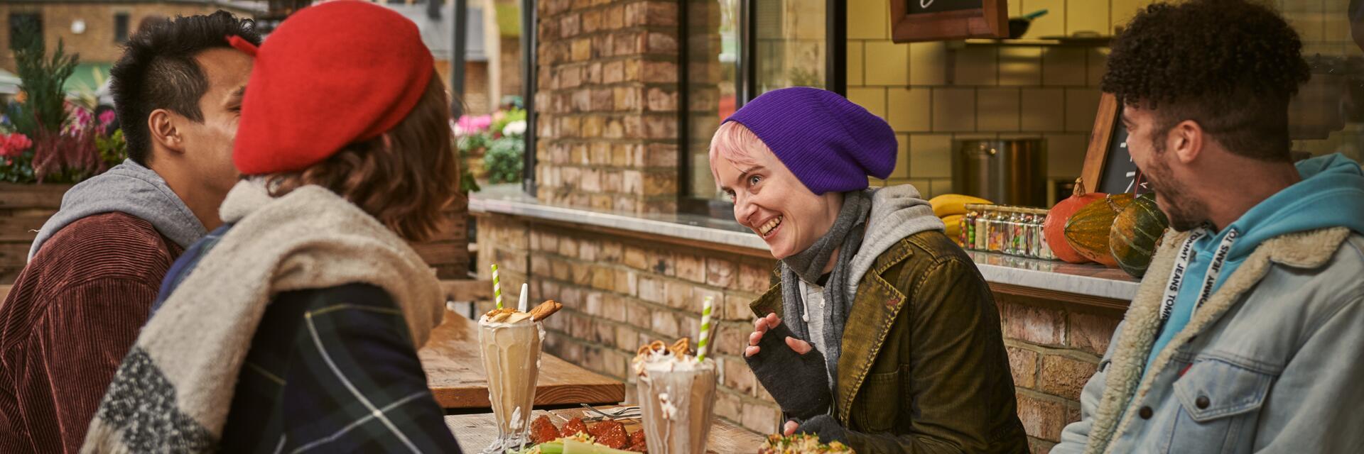 Friends eating a meal outside a restaurant