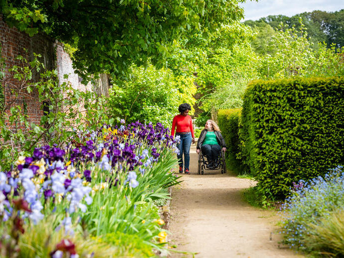 Two women in a Walled Garden, one using a wheelchair