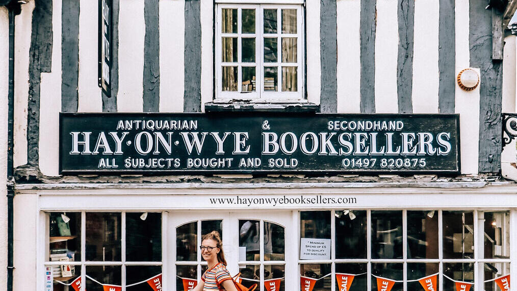 Une femme passant devant une librairie