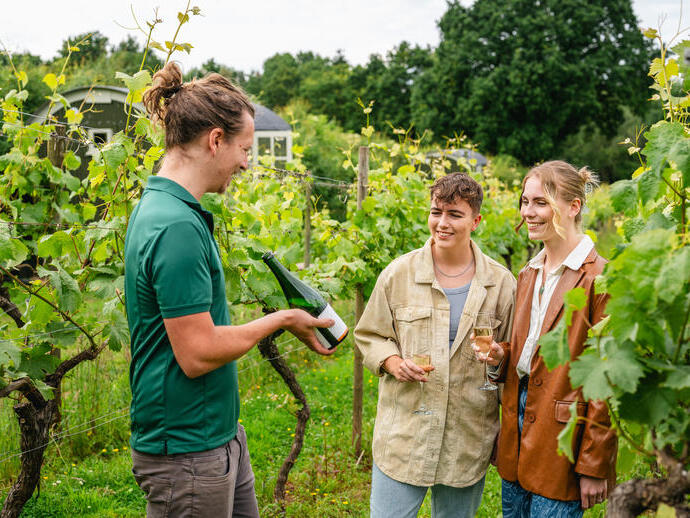 Two women enjoying a guided Vineyard tour and wine tasting experience