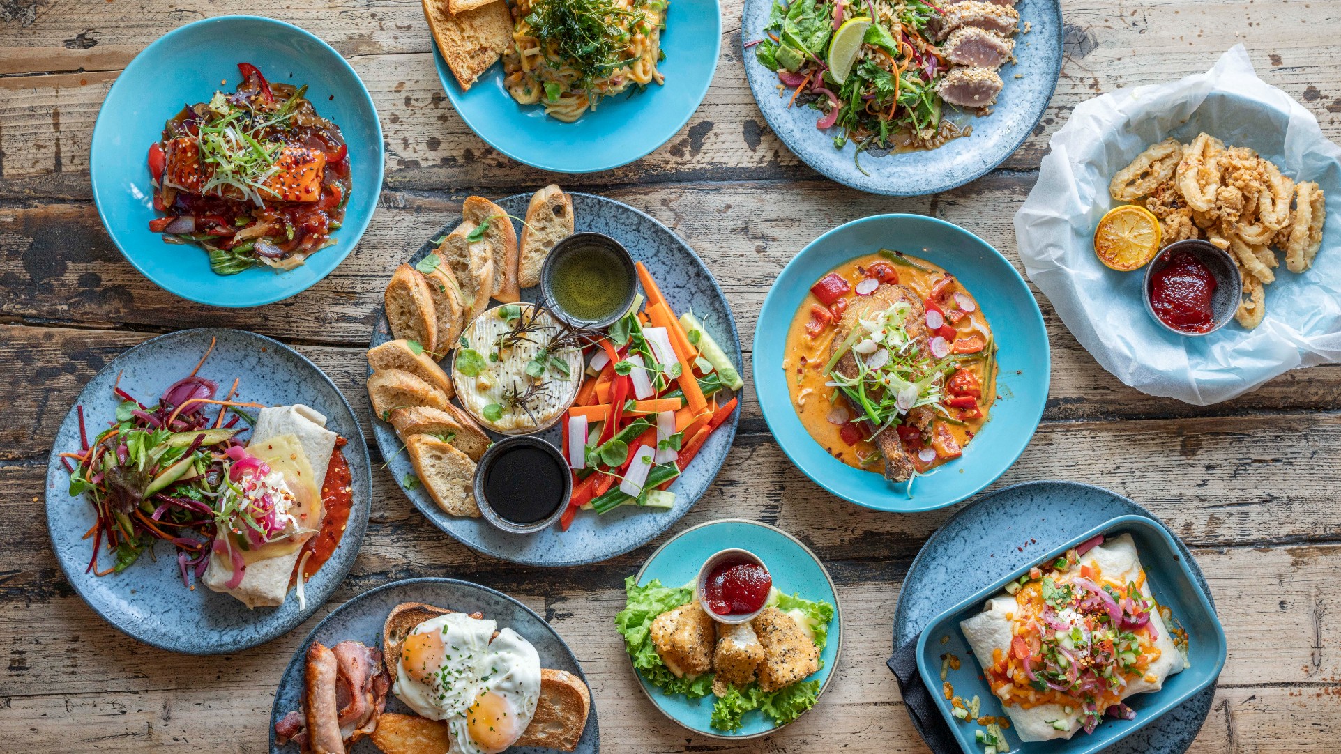 Plates of fine food presented on a restaurant dining table.
