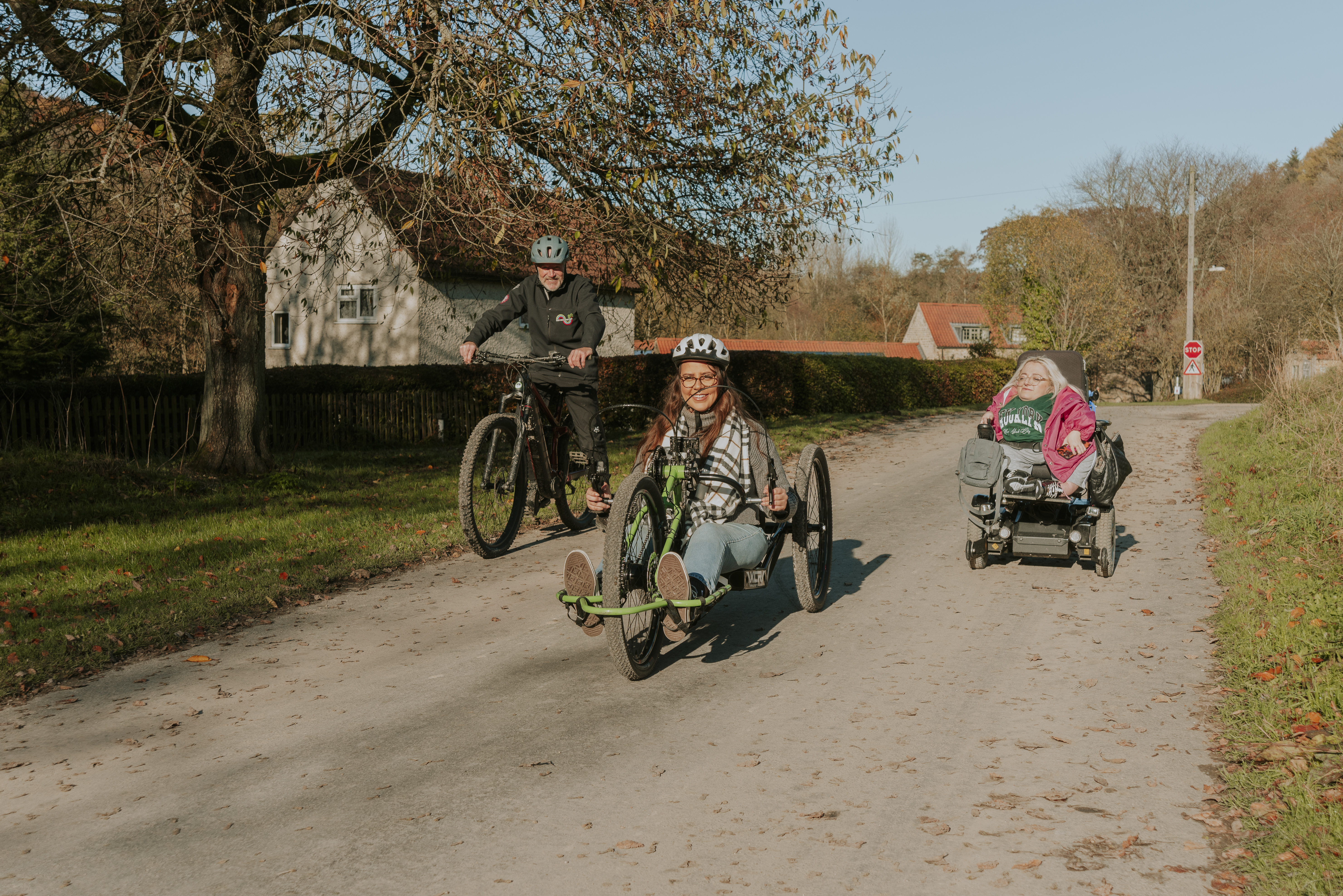 A woman using a hand bike with staff from the cycle hub